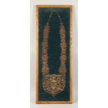 A FRAMED INDIAN GILT THREAD CHAIN OF OFFICE 'PBORGEETPOTRIA'. 3.5ins x 11.5ins.