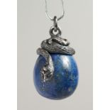 A RUSSIAN SILVER AND CARVED LAPIS EGG PENDANT.