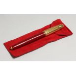 A GOOD CARTIER PASHADE BURGUNDY AND RED FOUNTAIN PEN, with 18 carat gold nib, in a fitted case