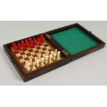 A SMALL COLUMD IVORY TRAVELLING CHESS SE with folding case board. 5.75ins.