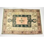 A PERSIAN CARPET, pink and green ground, with stylised decoration. 8ft x6ft 6ins.