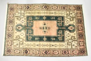 A PERSIAN CARPET, pink and green ground, with stylised decoration. 8ft x6ft 6ins.
