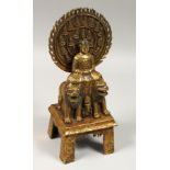 A GILT BRONZE GOD, sitting on two lions, 11ins high.