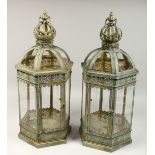 A PAIR OF CIRCULAR METAL AND GLASS HEXAGONAL LANTERNS, 27ins high.