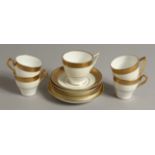 A SET OF FIVE MINTON HARLEQUIN COFFEE CUPS AND SAUCERS with acid etched gilded bands, various
