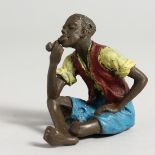 A PAINTED COLDCAST BRONZE MAN SMOKING A PIPE. 2.5ins high.