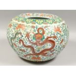 A GOOD CHINESE PORCELAIN CIRCULAR YELLOW, RED AND GREEN DRAGON POT, 14ins diameter.