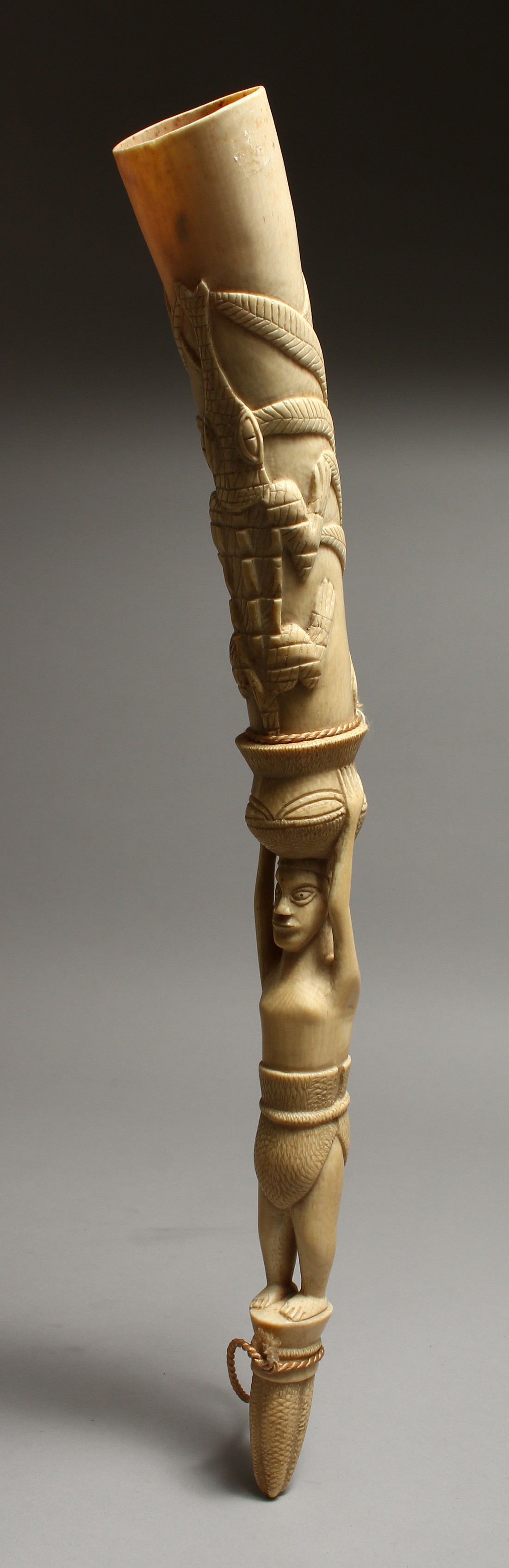 A CARVED IVORY OLIPHANT. 18ins long.