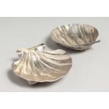 A PAIR OF SILVER .900 SHELL DISHES.