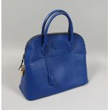 A BLUE LEATHER BAG with chrome lock. 13.5ins x 11ins