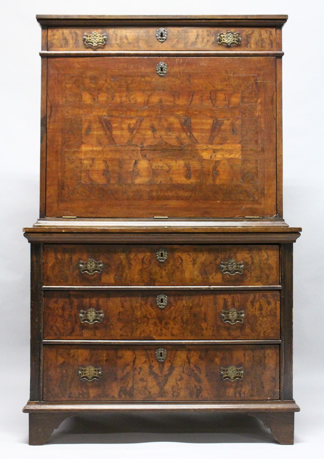 AN 18TH CENTURY WALNUT ESCRITOIRE, with a frieze drawer above the fall flap, enclosing a small