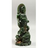 A CHINESE CARVED JADE GUANYIN FIGURE, 8.5ins high.