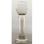 A LARGE WINE GLASS, the bowl engraved with sporting dog, the stem with white hart air twist, 9.