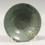 A SMALL CHINESE CELADON CIRCULAR DISH, 5.5ins diameter.