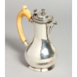 AN 18TH CENTURY SILVER JUG with ivory handles. 5.5ins high.