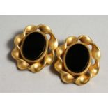 A PAIR OF LISA JONES GILT AND BLACK STONE EAR RINGS.