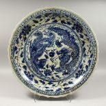 A LARGE CHINESE BLUE AND WHITE PLATE with dragon design, 23ins.