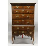 A GOOD 18TH CENTURY WALNUT CHEST ON A STAND with a concave moulded cornice over two short and