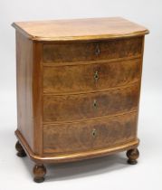 A WALNUT FRONTED, BOW FRONTED CHEST OF FOUR LONG GRADUATED DRAWERS on bun feet. 2ft 5ins wide, 1ft