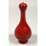 A SMALL CHINESE RED OVIOD SHAPED VASE, mark in blue, 7ins high.