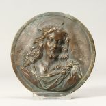 A SMALL BRONZE CLASSICAL PLAQUE OF CHRIST. 3.5ins diameter.