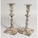 A PAIR OF OLD SHEFFIELD PLATE CANDLESTICKS. 9ins high.