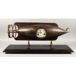 A GOOD BRONZE TORPEDO SHAPED CLOCK, with circular dial on a marble base. 30ins long.