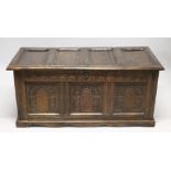 AN 18TH CENTURY OAK COFFER with a panelled top and triple panelled front, carved with arches. 4ft