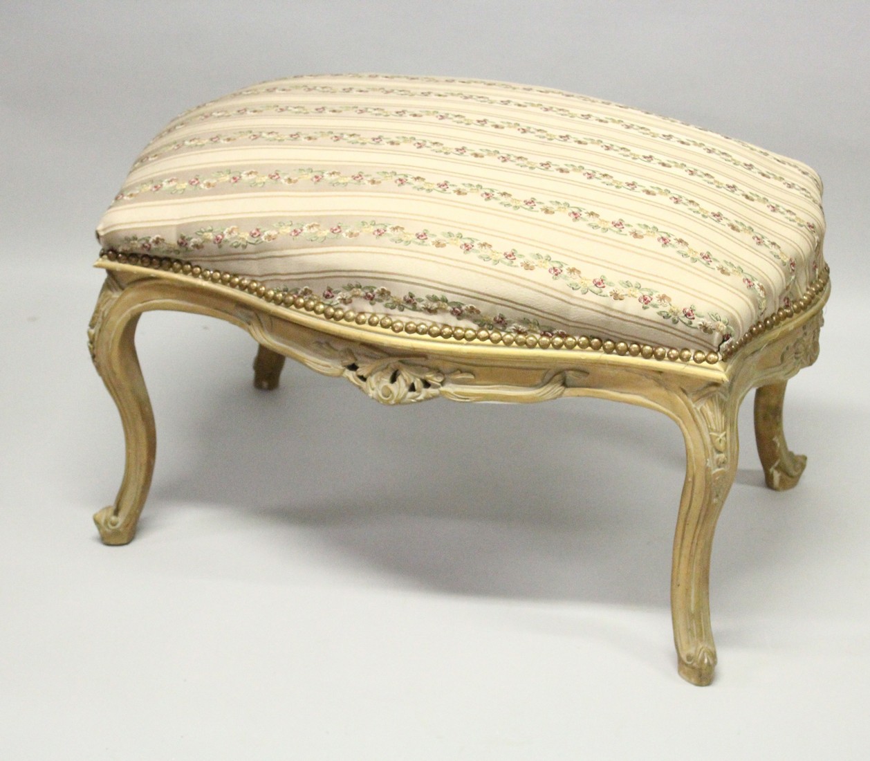 A GILT FRAMED WINDOW SEAT with floral cover