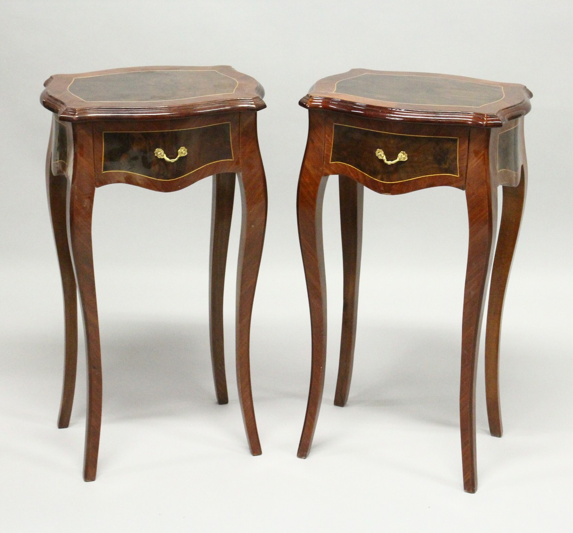 A PAIR OF FRENCH STYLE BEDSIDE TABLES with single drawer on curving legs. 2ft 6ins high.