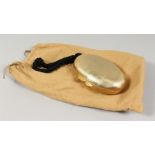 AN ASPREY, GOLD COLOURED METAL, EGG SHAPED EVENING BAG, with velvet lining and rope handle. Signed