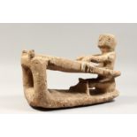 A CARVED LAVA INUIT SLEDGE AND RIDER. 14ins long 10ins high.