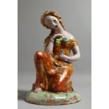 A CSERF POTTERY NUDE OF A YOUNG SEATED WOMAN, holding a bird. Signed. 1928. 10.5ins high.