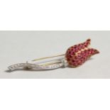 AN 18CT WHITE AND YELLOW GOLD TULIP BROOCH set with rubies and diamonds.