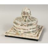 A FINE MOTHER OF PEARL ISLAMIC TEMPLE with calligraphy, the top opening to reveal a red velvet