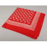 AN YVES ST. LAURENT SILK SCARF. Red with white pattern. 34ins x 36ins.