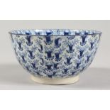 A 19TH CENTURY BLUE AND WHITE BOWL, painted all over with a stylised floral design. 4.5ins