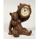 A GOOD VICTORIAN CARVED BLACK/ ONYX BEAR CLOCK. 7ins high.