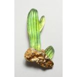 A DAUM GILT QAND GLASS CACTUS BROOCH. 3ins long.