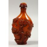 A CHINESE CARVED AMBER SNUFF BOTTLE