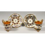 A GOOD PAIR OF 19TH CENTURY FRENCH PORCELAIN CUPS AND SAUCERS, one with gilt dog and goats the other