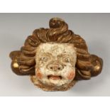 A 17TH CENTURY CARVED LIMEWOOD CHERUBS HEAD. 17ins long x 8ins high.