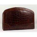 A GOOD, VINTAGE ASPREY OF LONDON, CROCODILE SUIT CASE, with velvet interior and bow front. 24ins