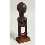 A LARGE TRIBAL CARVED WOOD PULLEY as a female figure. 10.5ins high.