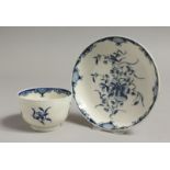 AN 18TH CENTURY WORCESTER TEABOWL AND SAUCER, painted inthe blue with a large trailing flower,