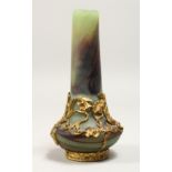 A SMALL ART NOUVEAU DESIGN MOTTLED GREEN GLASS BOTTLE VASE, overlaid with ormolu and mounts. 6ins
