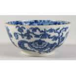 A 19TH CENTURY BLUE AND WHITE BOWL, painted with an urn of flowers. 5.25ins diameter.