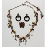 A GOOD MONIES SILVER AND AMBER NECKLACE AND HORN EARRINGS in a black bag.