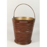 A DUTCH MAHOGANY PEAT BUCKET with brass liner and handles.12ins high.