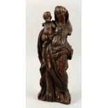 A 17TH CENTURY CARVED WOOD MADONNA AND CHILD. 17ins high.